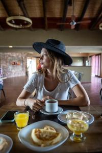 a woman sitting at a table with a plate of food at Hotel Castillos de Cafayate in Cafayate +42 photos
