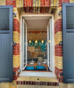 a view of a kitchen from a brick building at Belle Maison centre Villerville - 8 personnes - Terrasse in Villerville