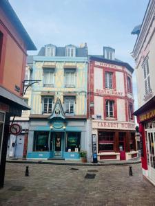 a group of tall buildings on a city street at Maison centre Villerville in Villerville
