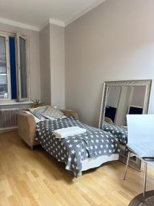 a bedroom with two beds and a mirror at Bright 1BR apartment in Kallio with best location in Helsinki