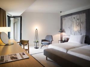 a hotel room with a bed and a desk and chairs at Hotel Kompas in Dubrovnik