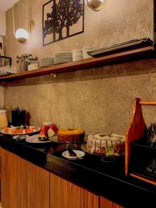 a kitchen counter with plates of food on it at Ocean Praia Hotel in Fortaleza +20 photos