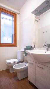 a bathroom with a toilet and a sink and a window at Venezia 1851 in Venice +18 photos