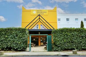 a building with a sign that reads hotel fireplace universe at Première Classe Plaisir Gatines in Plaisir