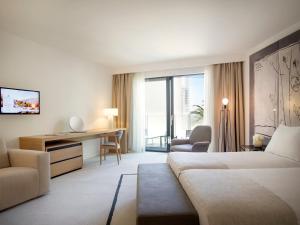 a hotel room with a bed and a desk at Hotel Kompas in Dubrovnik