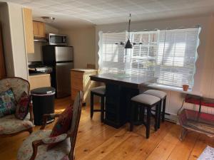 a kitchen with a table and chairs in a room at The Hideaway in Brewster +7 photos