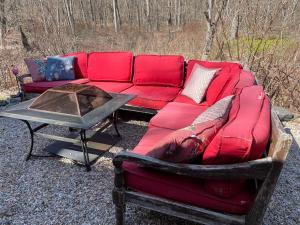 a red couch sitting next to a table at The Hideaway in Brewster