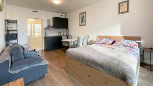 a bedroom with a bed and a couch and a table at Matilda108 in Prague