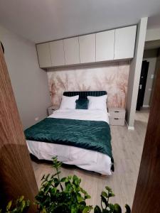 a bedroom with a large bed with a large headboard at Happy Studio Luxury Pipera in Voluntari