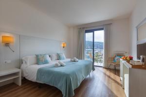 Postel nebo postele na pokoji v ubytování Hotel Miramar