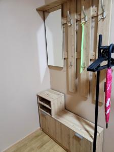 a room with a closet with a bench and an umbrella at Apartman "CHARLIZE" with PRIVATЕ PARKING in Novi Sad