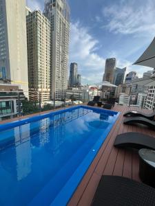a large swimming pool on the roof of a building at Emiri Hotel - Nana Bangkok in Bangkok