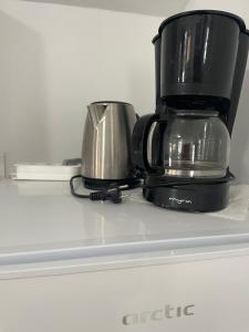 two coffee pots sitting on top of a refrigerator at Cabanute Luca Ama Bran in Bran