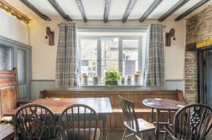 a dining room with a table and chairs and a window at The Royal Oak, Gladestry in Gladestry