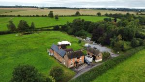 an aerial view of a house in a field at Elderbrook House in Avebury