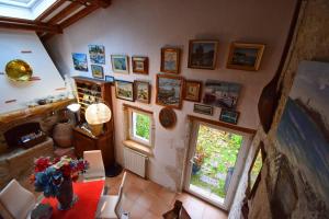 a room with pictures on the wall and a table at Maison à Sauvagnas avec piscine - Clévacances 3 clés in Sauvagnas