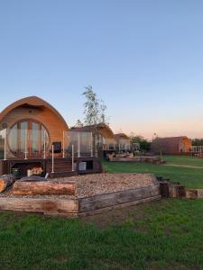 a house with a fire pit in the middle of a field at Hundle Dale- Bugthorpe Grange Glamping in Stamford Bridge