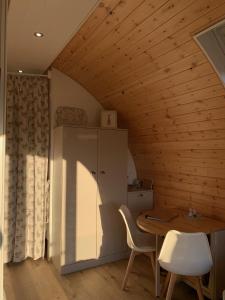 a kitchen with a table and chairs in a room at Hundle Dale- Bugthorpe Grange Glamping in Stamford Bridge +20 photos