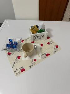 a white table with a cup on top of it at Come a casa tua, vicino Milano! in Parabiago