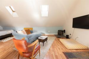 a living room with a couch and a tv at Bluebird Day - Pine Hideaway in Bend
