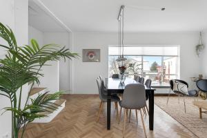 a dining room with a black table and chairs at Lovely & Spacious Apartments in Reykjavík