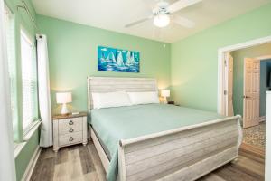a bedroom with a bed and a ceiling fan at Casa Azul - 4B Beach Home in Pensacola Beach +62 photos