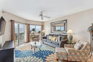 a living room with a couch and a table at Emerald Isle Gulf Front 2B Condo - 104 in Pensacola Beach
