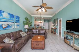 a living room with a couch and a flat screen tv at Emerald Isle Gulf Front 2B Condo - 1706 in Pensacola Beach