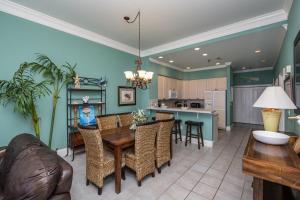 a kitchen and dining room with a table and chairs at Emerald Isle Gulf Front 2B Condo - 1706 in Pensacola Beach