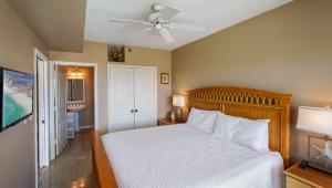 a bedroom with a bed and a ceiling fan at Emerald Isle Gulf Front 2B Condo - 104 in Pensacola Beach +19 photos