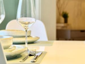 a glass of white wine sitting on a table at Ferienwohnung Oberwinter bei Bonn in Bandorf