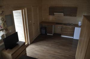 a small kitchen with a sink and a counter at Domki caloroczne Hotel Zagiel in Niewiesze