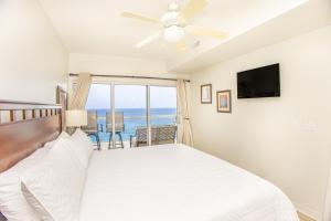 a bedroom with a bed and a balcony with the ocean at Emerald Isle Gulf Front 3B Condo - 1208 in Pensacola Beach +27 photos