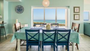 a dining room with a table and a view of the ocean at Emerald Isle Gulf Front 3B Condo - 301 in Pensacola Beach