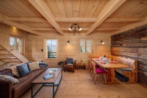 a living room with a couch and a table at Chalet Les Aragnes Family chalet La Tzoumaz in Riddes