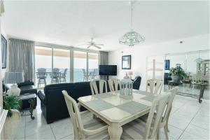 a dining room and living room with a table and chairs at Regency Towers Gulf Front 3B Condo in Navarre