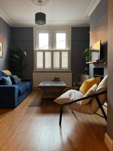 a living room with a couch and a table at Townhouse in trendy suburb of Hoole in Chester