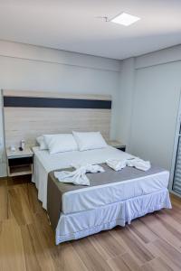 Postel nebo postele na pokoji v ubytování Olavo Bilac Hotel
