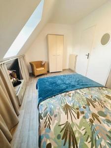 a bedroom with a bed and a tv in it at Maison néo-bretonne in Plouzané