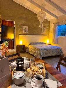 a bedroom with a bed and a table with food on it at La Serena Suites Aparthotel in La Paloma