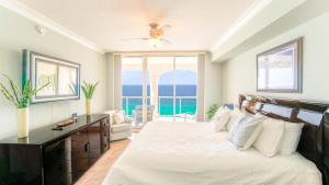 a bedroom with a bed and a large window at Beach Club Gulf Front 3B Condo - 1203 in Pensacola Beach +43 photos