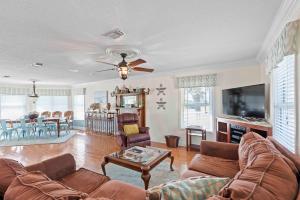 a living room with a couch and a table at Sea Breeze - 5B Beach Home in Pensacola Beach