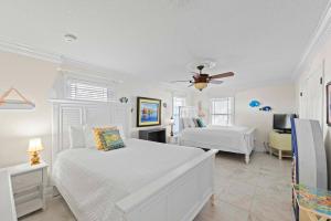 a bedroom with two beds and a ceiling fan at Sea Breeze - 5B Beach Home in Pensacola Beach