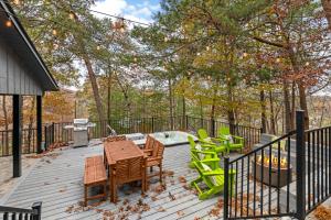 a deck with a table and chairs and a hot tub at Dolly's Outdoor Oasis in Sevierville