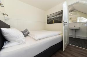 Postel nebo postele na pokoji v ubytování Haus Poggfred Whg 05 Sönnen + 3 fotografie