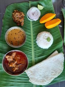 a plate of food on top of a banana leaf at Nakshatra Villa - A Relaxing Villa in Alibag in Revadanda