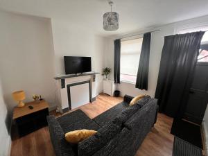 a living room with a couch and a fireplace at Visit Luton With This 2 BR Rental - Sleeps 6 in Luton