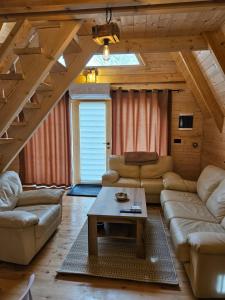 a living room with a couch and a table at Wilderness Cabin in Kolašin