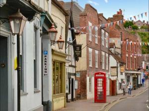 a street with a red phone booth and buildings at The Court in Bridgnorth