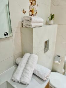 a pile of towels sitting on a counter in a bathroom at Appartement bord de mer Agadir in Agadir